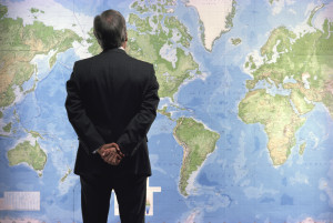 businessman-world-map-wall