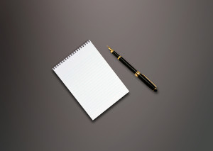 a pen and blank paper on the table