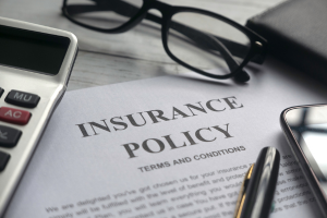 image of an insurance policy and eyeglasses