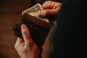 image of man's hands taking cash from his wallet
