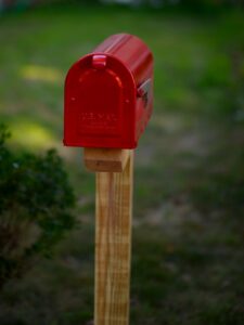 red mailbox on a wooden post